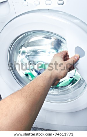 clothes washer with arm and green fabric