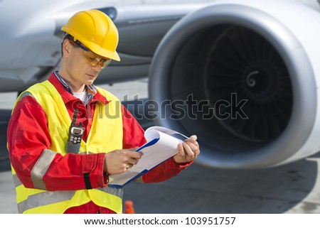 Airline safety engineer going through a pre-flight checklist