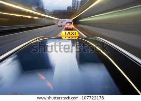 Taxi being pulled over by a police car for speeding