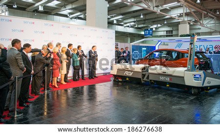 HANOVER, GERMANY - APRIL 7: German Chancellor Angela Merkel during a technology showcase tour of innovations in industrial Robotics used in the Automotive industry. 7 April 2014