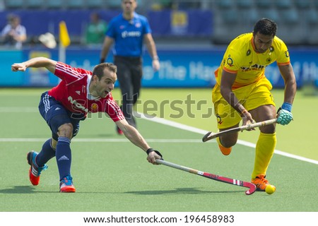 THE HAGUE, NETHERLANDS - JUNE 2: Englishman Catlin reaches for the ball to stop a rush by Indian player Raghunath  during the Hockey World Cup 2014 GBR beats IND 2-1