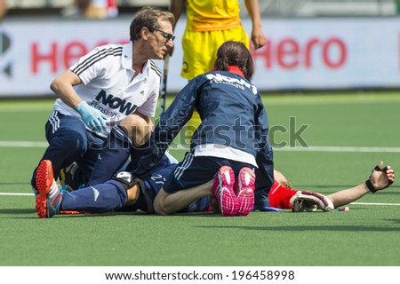 THE HAGUE, NETHERLANDS - JUNE 2: Doctors tend to injured England player Ashley Jackson during the Rabobank World Cup Hockey 2014 in the match against India. GBR beats IND with 2-1