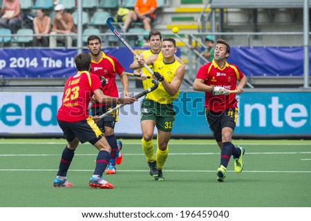 THE HAGUE, NETHERLANDS - JUNE 2: Australian Hayward lifts his stick to control a high ball, surrounded by Spanish players during the Hockey World Cup 2014  AUS beats SPA 3-0