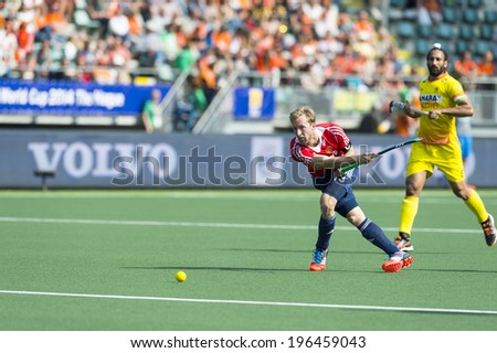 THE HAGUE, NETHERLANDS - JUNE 2: English Player Barry Middleton passes the ball forward during the match between England and India (2-1) at the World Cup Hockey
