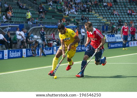 THE HAGUE, NETHERLANDS - JUNE 2: Englishman Catlin reaches for the ball to stop a rush by Indian player Raveendran  during the Hockey World Cup 2014. GBR beats IND 2-1