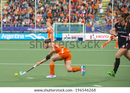 THE HAGUE, NETHERLANDS - JUNE 2: Dutch Jonker is passing the ball Belgium player De Groof is right behind her during the Hockey World Cup 2014 (women) NED beats BEL 4-0