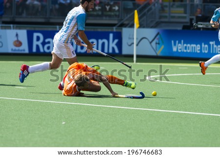 THE HAGUE, NETHERLANDS - JUNE 1: Dutch player Hertzberger is laying on the ground. Brunet is taking over te ball during the Hockey World Cup. NED beats ARG 3-0