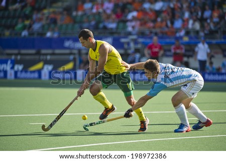 THE HAGUE, NETHERLANDS - JUNE 13: Argeninian Gonzalo Peillat falls short in recovering the ball from Australian star player Jamie Dwyer during the semi finals of the world championships hockey in 2014