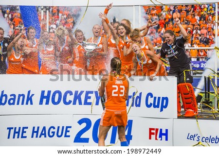 THE HAGUE, NETHERLANDS - JUNE 14: Kim Lammers treats her team with a champagne shower during the prize giving ceremony after winning the world championships hockey in 2014
