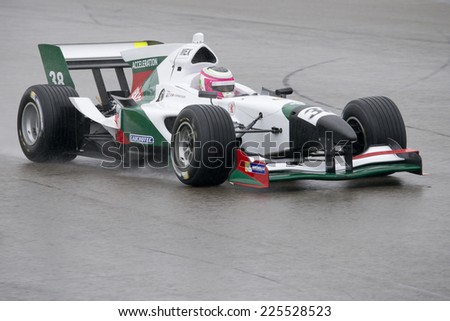 ASSEN, NETHERLANDS - OCTOBER 19, 2014: Team Mexico\'s car racing on a wet TT circuit during the final race of the acceleration FA1 Grand Prix European Circuit.