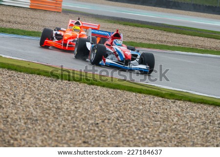 ASSEN, NETHERLANDS - OCTOBER 19, 2014: Team Netherlands in pursuit of Team Great Britain during the final race of the Formula A1 GP Acceleration tour.
