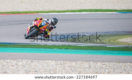 ASSEN, NETHERLANDS - OCTOBER 17, 2014: Driver 10 races through corner 3 during the free trials of the 1000cc motorbike division