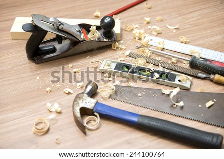 Jack plane with carpentry tools and wood shavings on floor
