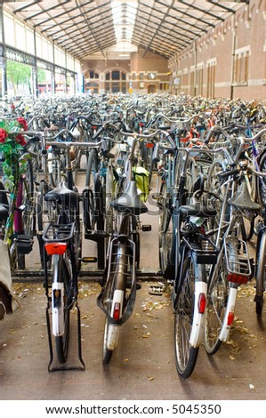 Rows and rows of bicycles parked at a railway station.