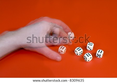 A man\'s left arm changing a dice, cheating at a game