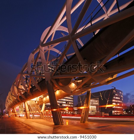 The modern looking, futuristic elevated tram line in the Hague, the Netherlands at night
