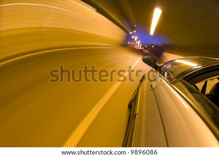 A car speeding towards the exit of a tunnel