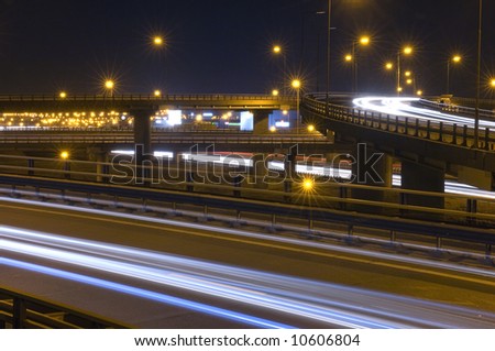 Traffic on an Highway Over pass or fly-over with motionblurred head lights