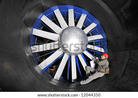 An engineer, checking up on the mechanical structure inside a wind tunnel