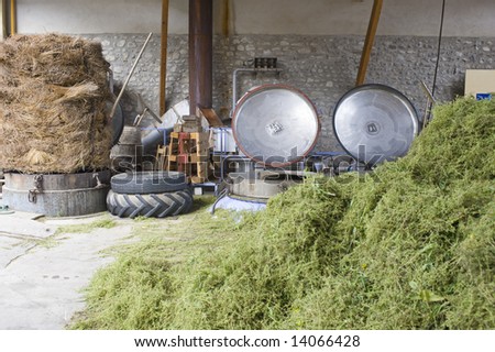 The herbal essences distillery, with a heap of thyme in the foreground, the pressure cookers, used to distill the essences, with their open lids and a bale of lavender on the right