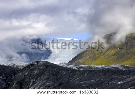 A glimpse through the clouds on the Svinafellsjokull glacier, one of the arms of the famous Icelandic Ice cap, the Vatnajokull