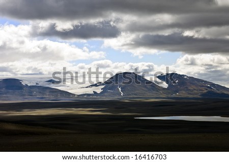 The barren tundra of the Sprengisandur Highlands in Iceland, with the dominating Vatnajokull glacier in the background