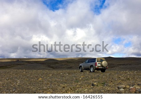A big four by four all terrain car in the vastness of the Icelandic tundra
