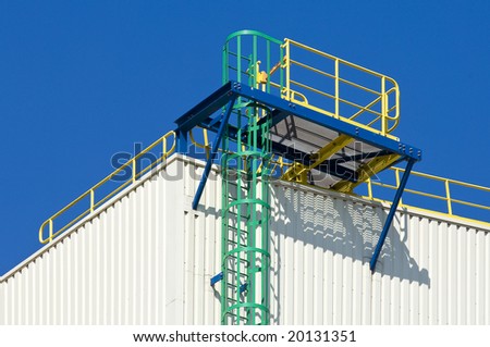 Brightly colored fire escape on an industrial building