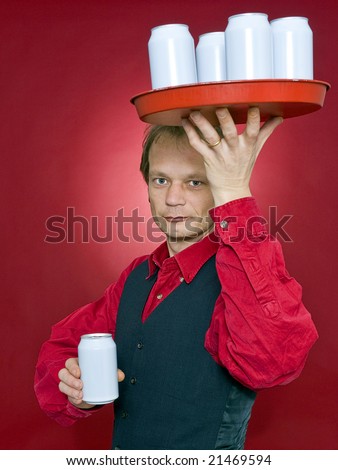 a waiter with a tray of beverage cans above his head holding out one can in his outstretched hand to a customer