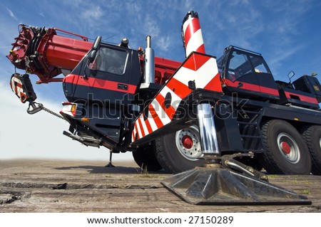 A huge powerful mobile crane and its support stud, ready for action
