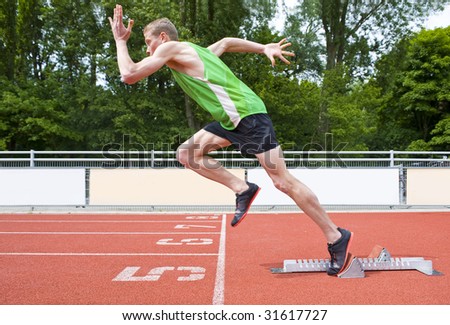 Explosive start of an Athlete leaving the starting blocks on a sprint run