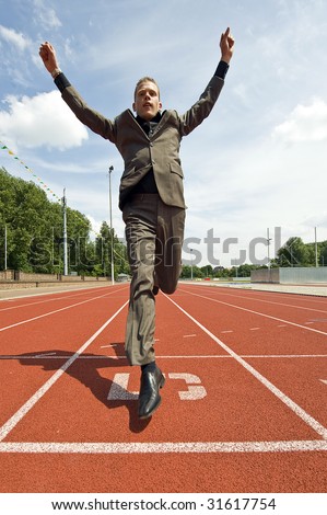 Metaphor For Success In Business - A Business Man Crossing The Finish ...