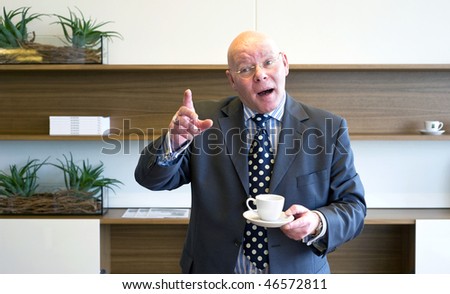 A senior manager, raising his finger, voicing a counter argument in a discussion