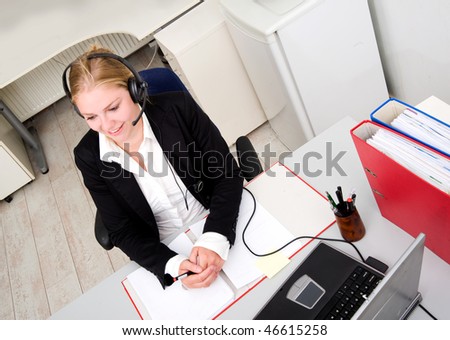 Friendly receptionist on the phone wearing a headset and microphone
