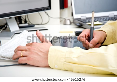 The hands of a graphic designer, simultaneously hovering the shift, control, alt and command button, and sliding a stylus over a graphic tablet