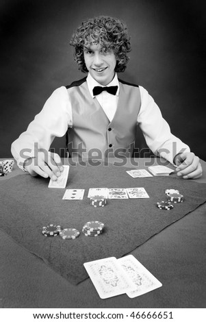 A poker dealer smiling friendly at a player during a casino game