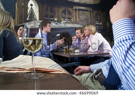 several customers having a discussion in a bar