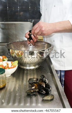 A chef and his sous-chef working in a kitchen