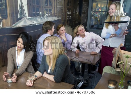 a waitress laughing with her customers