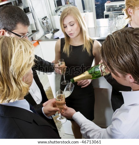 Waiter refilling his guests glasses with champagne