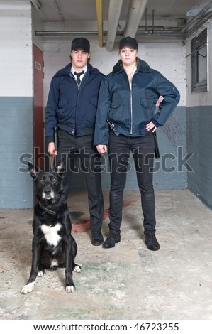 Portrait of two young police officers of a k9 squad