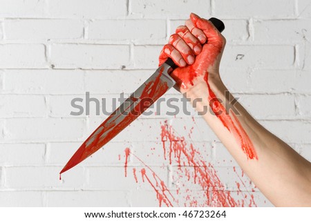 stock photo : Blood covered knife, still dripping, in the hands of a 