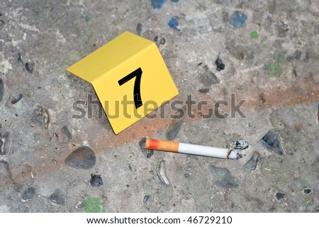 Evidence at a fresh crime scene: ash, a cigarette with lipstick ...