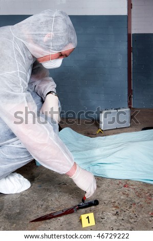 stock photo : Forensic expert dusting for fingerprints on knife - the murder 