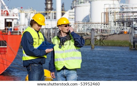 Two dockers during a routine inspection of an industrial harbor