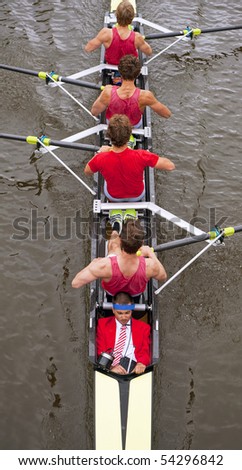 Close up of a coxed four rowing team, seen from above