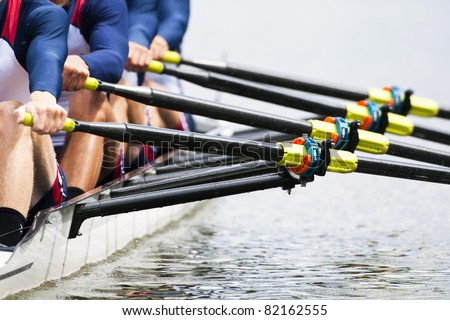 Close up of a men\'s quadruple skulls rowing team, seconds after the start of their race