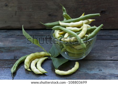freshly picked green beans pods, wooden background