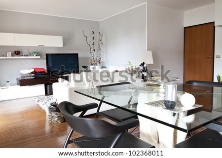 Interior decoration of a living room, glass table and tv