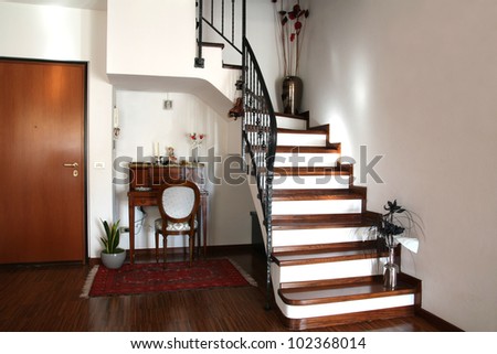 Interior decoration of a room with stairs and antique desk with chair